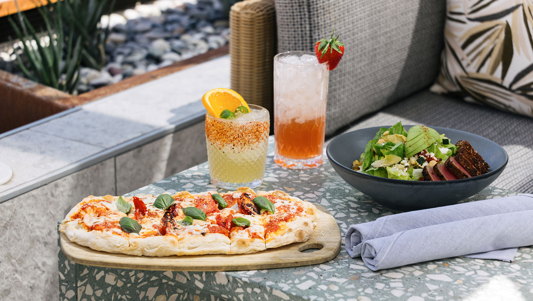 Eden Rooftop Bar pizza with salad and drinks