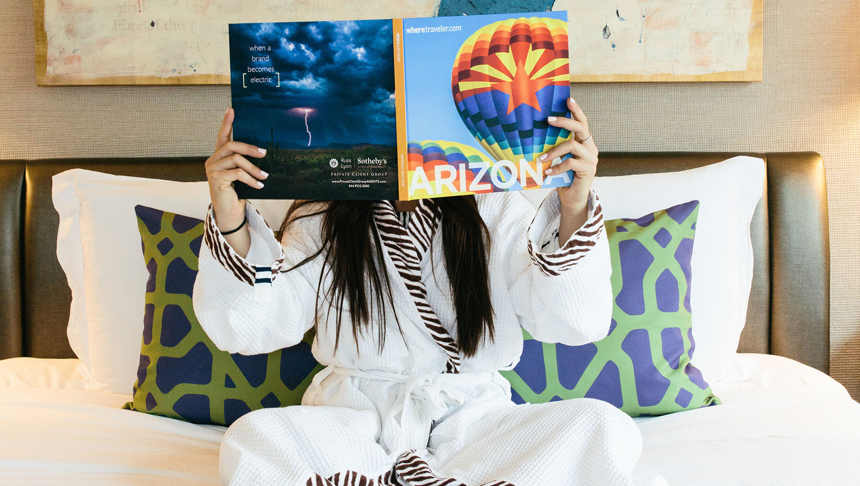 Woman on bed reading Arizona Magazine