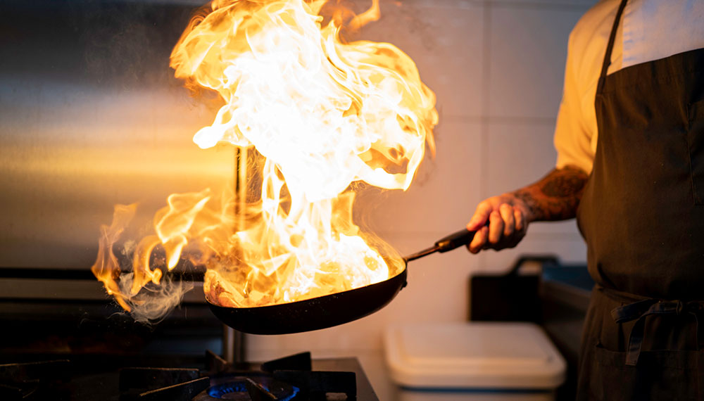 Chef with fire in pan