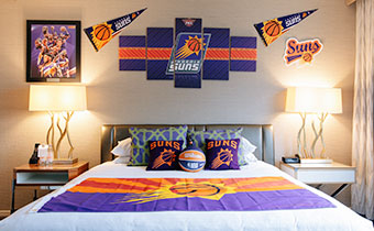 a bedroom with a bed and Phoenix Suns basketball decorations